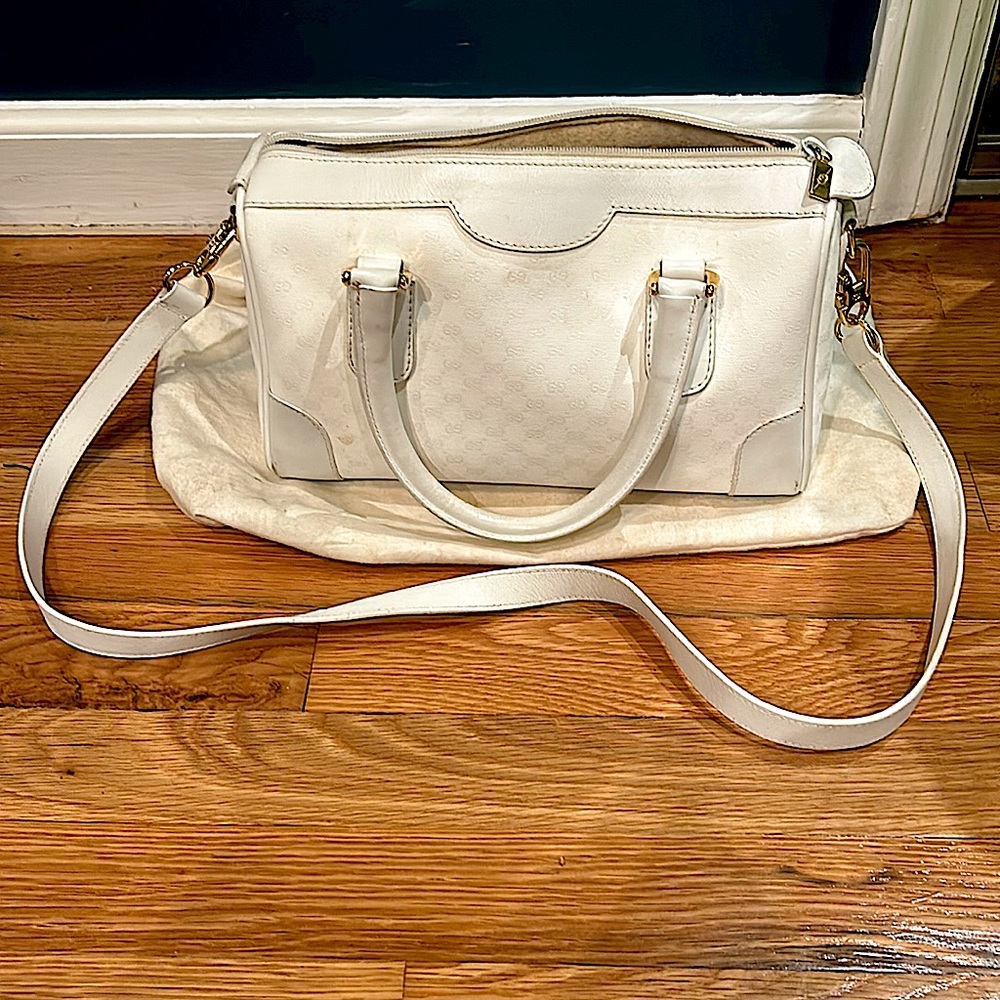 White Gucci handbag with shoulder strap. Gold accents.